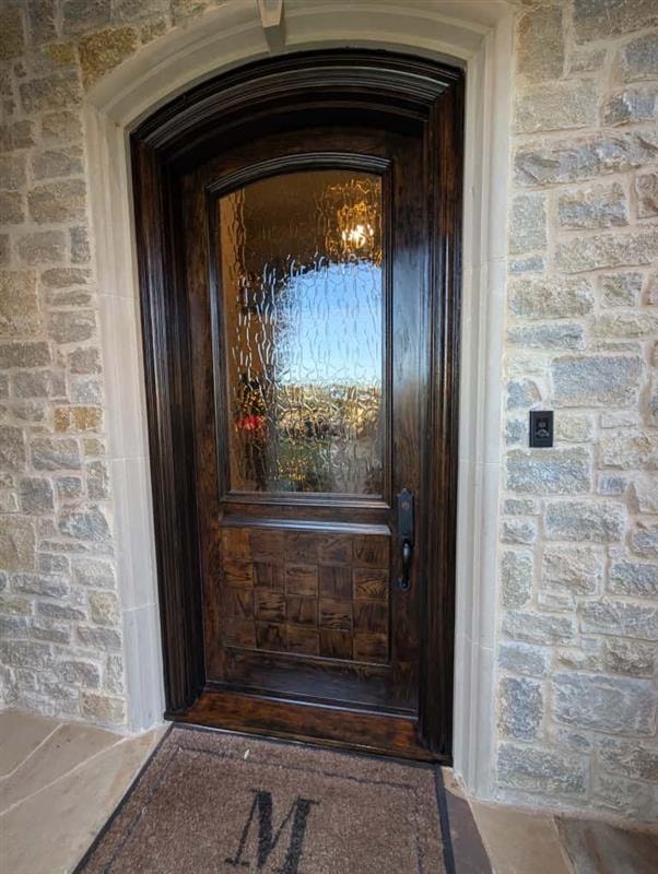 Front door after — deep dark stain, refinished lower panel